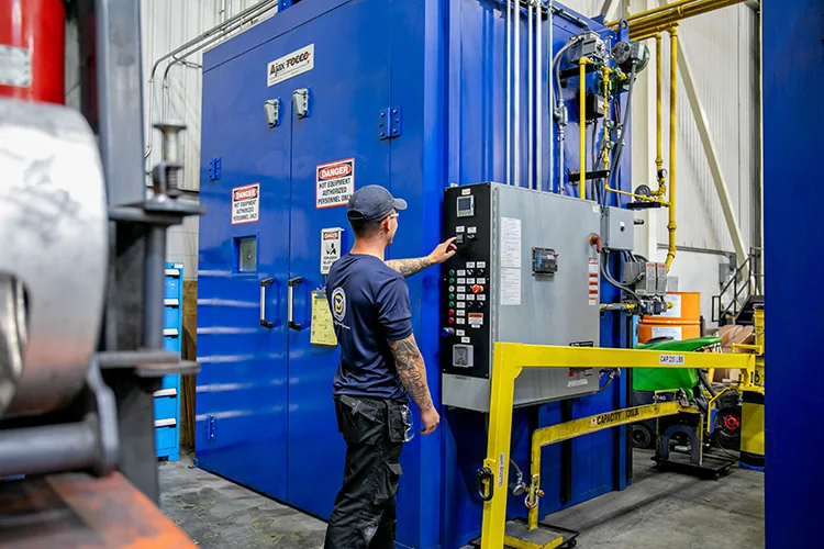 Denaeyer technician working on an industrial mechanical system.