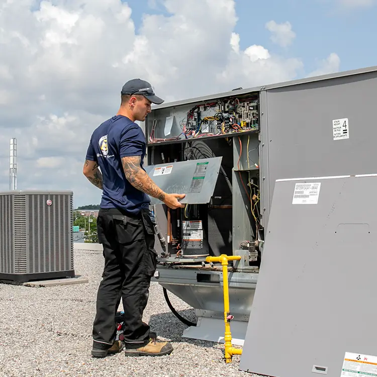 Denaeyer technician servicing rooftop equipment.