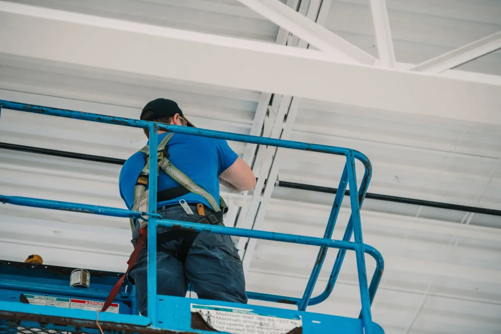 Denaeyer technicians installing overhead mechanical services.