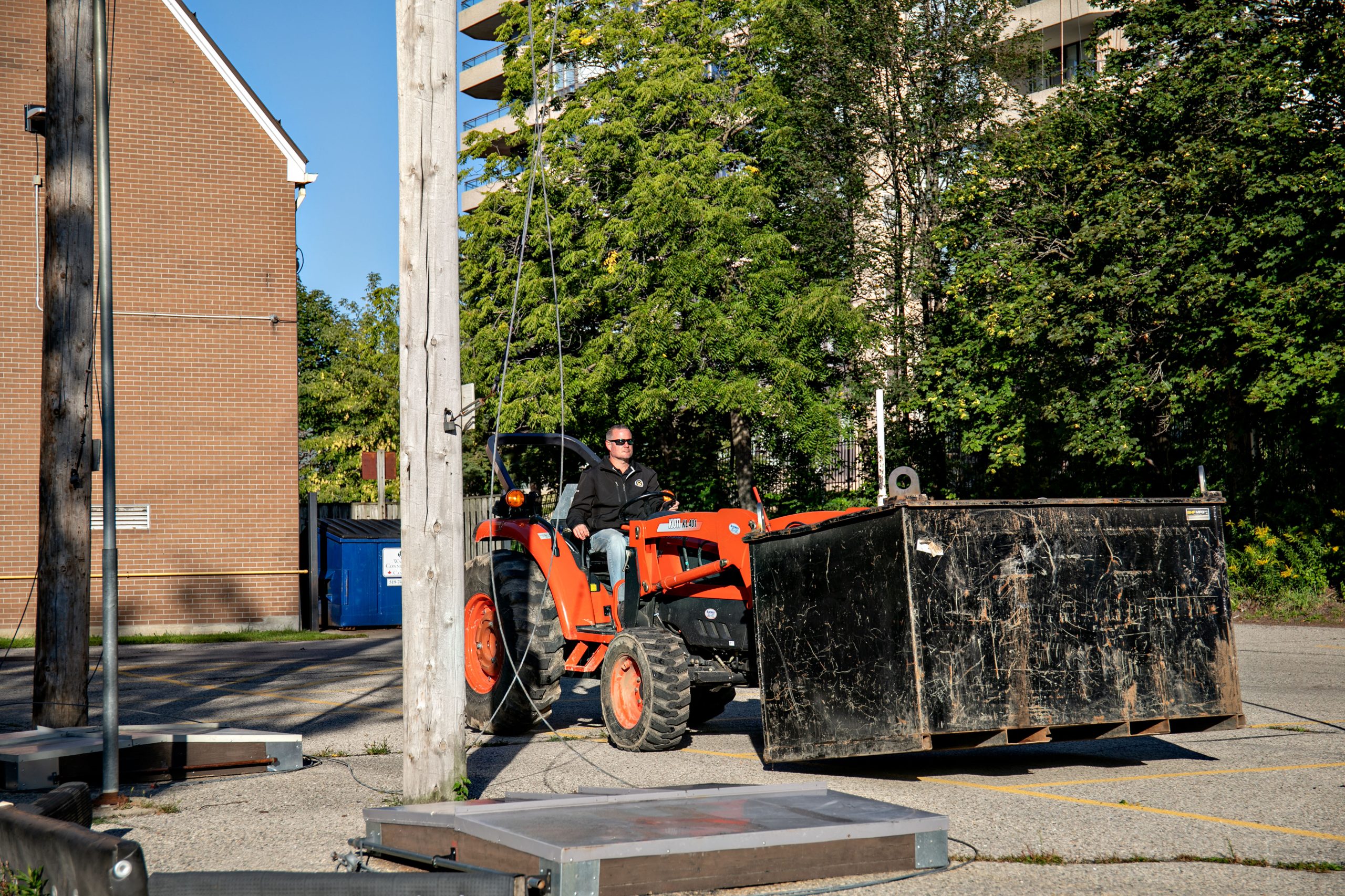 Loader and material container beside the Waterpark Place staging area.