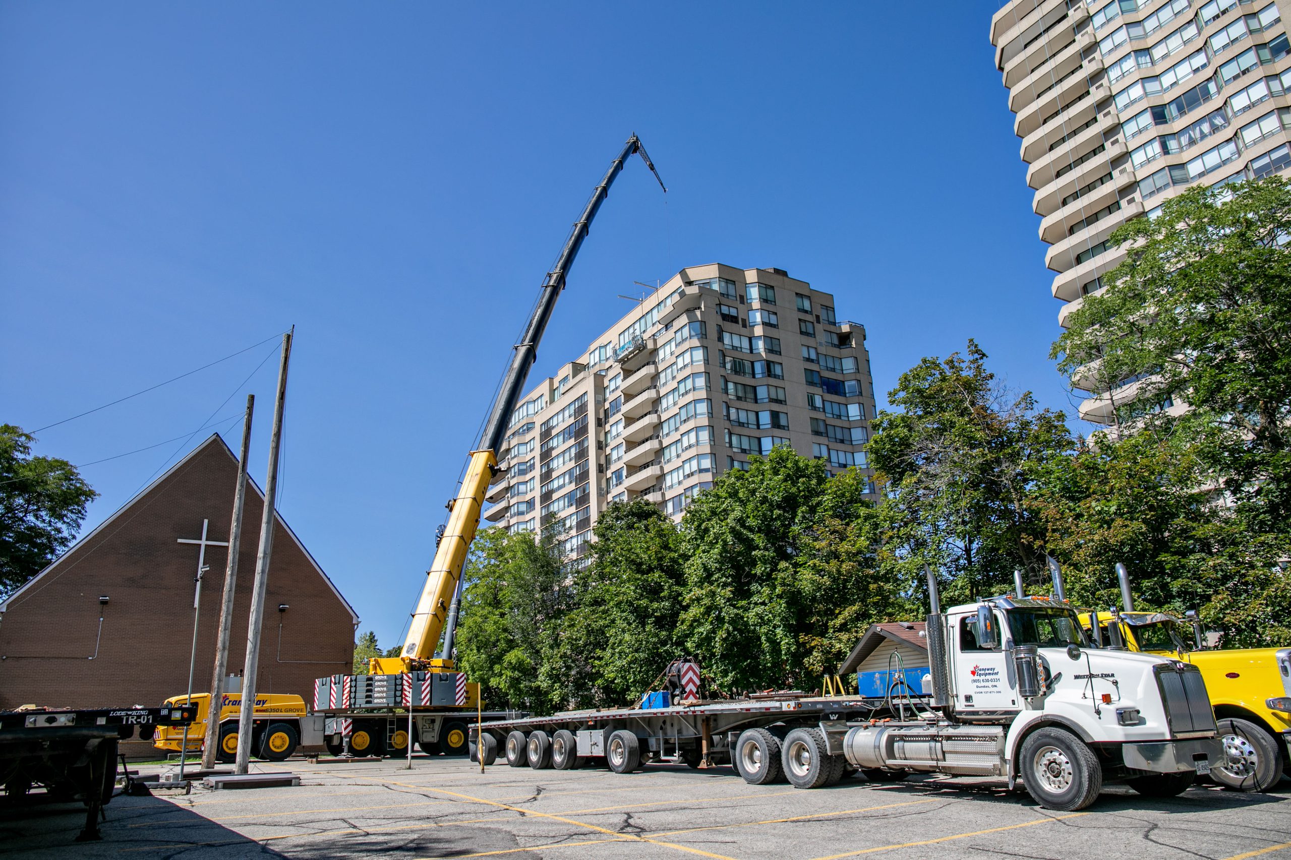 Crane, support vehicles and a condominium tower at Waterpark Place.