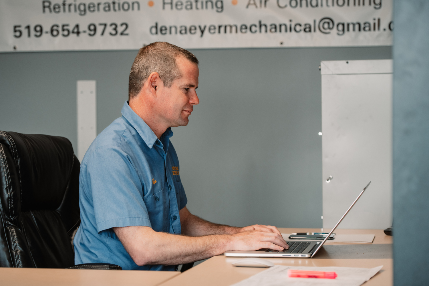 Denaeyer Mechanical team member planning work at a desk.